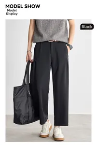 Men's black textured straight leg trousers showing elegant drape and urban casual style