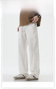 Detail of white Cityboy loose casual pants with elastic drawstring waist and side stitching