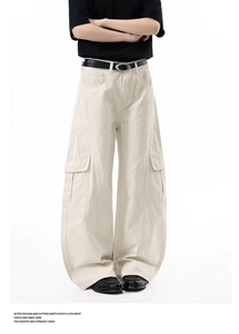 Detail of light beige utility cargo pants featuring side flap pockets and 3D cut silhouette