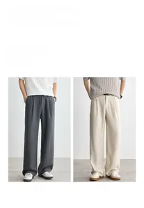 Detail of Lyocell textured wide-leg trousers in grey and apricot with elegant drape
