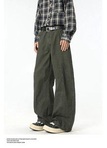 Detailed view of olive green cargo pants featuring wide-leg cut and premium cotton fabric