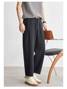 Minimalist men's black straight-leg trousers with front pleats and draped texture