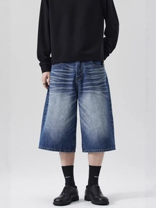 Retro washed denim jorts with whiskers and distressed details in a loose wide-leg fit