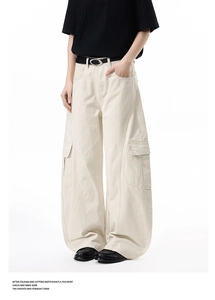 Detail of high-waist cargo pants with large flap pockets and vertical stitching seams