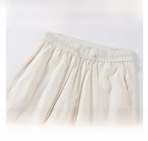 Detail of elastic drawstring waistband and stitching on off-white leisure pants