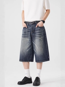 Deep blue heavy washed denim shorts with vintage whiskers and relaxed wide leg fit