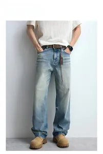 Detail view of vintage light blue washed denim jeans with whisker fades and straight fit