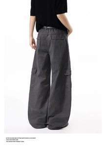 Macro shot of oversized wide-leg cargo pants featuring functional back pockets and stitching