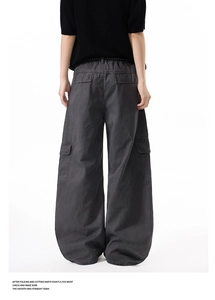 Rear view of dark grey multi-pocket wide leg cargo pants with vintage street style design