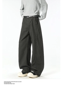 Detail of dark gray wide-leg cargo pants featuring vertical seams and a relaxed straight cut
