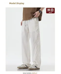 Men's relaxed fit white cargo pants with drawstring waist and side pocket details