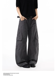 Detail view of charcoal grey high street cargo pants with functional side pockets