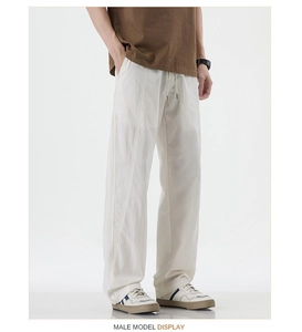 Detail of white cargo pants featuring drawstring waist and contrast stitching crafts