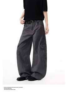 Detail of multi-pocket dark gray cargo pants showing fabric texture and stitching