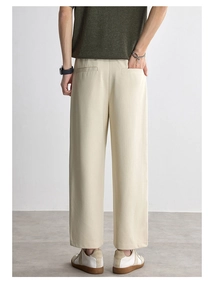 Rear view detail of cream straight-leg trousers showing premium texture and drape quality