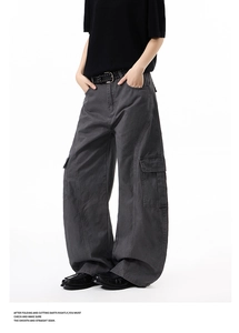 Detail of dark grey wide-leg cargo pants with large side pockets and stitching detail