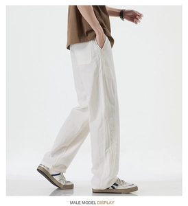 Detail showing white straight-leg pants with vertical stitching and lyocell texture