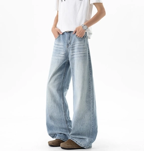Detail view of light blue wide-leg jeans with vintage cat-whisker wash and loose fit