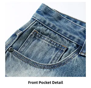 Close-up of front pocket on light blue denim jeans with orange stitching and metal rivet