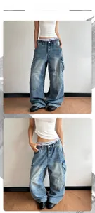 Detail of washed blue cargo jeans featuring large side pockets and relaxed wide-leg cut