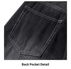 Détail macro d'une poche arrière en denim noir avec coutures contrastées blanches