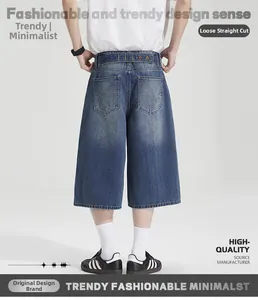 Detailed back view of loose straight denim shorts with decorative arch stitching on pockets