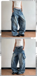 Detail of oversized vintage cargo jeans with heavy wash and large utility side pockets