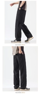 Detail of black Lyocell quick-dry trousers with side stitching and straight-leg cut