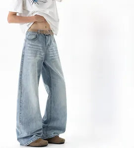 Detail view of light blue washed wide-leg jeans with waist belt and loose leg opening