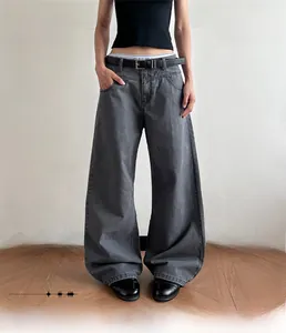 Detailed view of heavy washed denim texture on wide-leg high-waisted street trousers