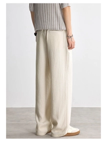 Detail view of cream Lyocell lounge pants featuring breathable texture and wide-leg back pockets