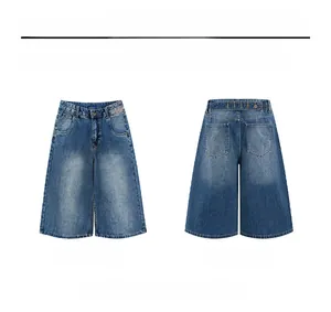 Flat lay of vintage blue denim wide-leg shorts featuring back buckle and washed details