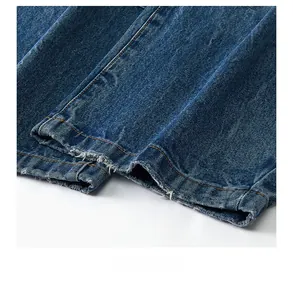 Detailed macro view of retro frayed denim hem with double-needle orange stitching