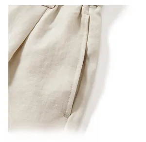 Detailed view of beige Lyocell fabric texture and smooth side pocket stitching