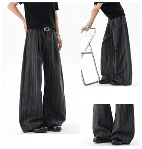 Detailed views of grey striped wide-leg trousers showing straight-cut fit and fabric texture