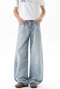 Close-up of light blue washed denim jeans showing cat whisker texture and high waist detail