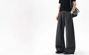 Close-up of grey vertical striped fabric texture and drape of men's wide-leg trousers