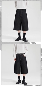 Detailed view of black wide-leg denim shorts with contrast stitching and loose A-line fit