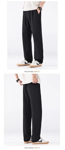 Présentation détaillée du modèle montrant le drapé du pantalon décontracté noir