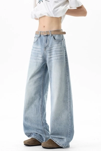 Detail showing vintage cat-whisker wash and high-waisted cut of light blue denim jeans