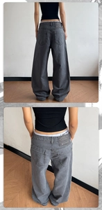 Detail of high street stone-washed khaki wide leg trousers with premium leather waist patch
