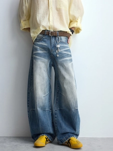 Vintage wash blue curved wide leg denim jeans with cat-whisker detailing for men