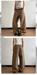 Detail view of high-waist khaki wide-leg trousers with a black belt and street style design