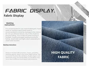 Detail view of washed blue slub denim fabric texture and garment care instructions