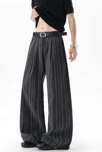 Detail view of men's striped wide-leg trousers featuring a dark grey fabric and vertical lines