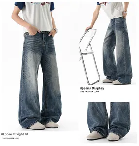 Detail of vintage blue wide leg jeans with cat whisker wash and stacked loose cuffs