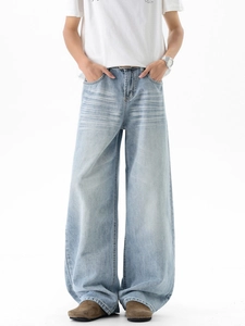 Men's vintage washed light blue wide-leg jeans with whiskered texture and loose fit