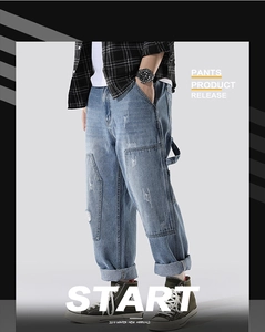 Detail of men's light blue straight denim pants with patch stitching and tool loop