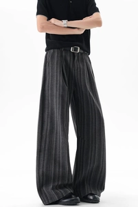 Detail view of retro pinstripe wide-leg trousers for men with elegant drape and black belt