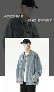 Close-up of light blue washed denim jacket featuring classic utility chest pockets design